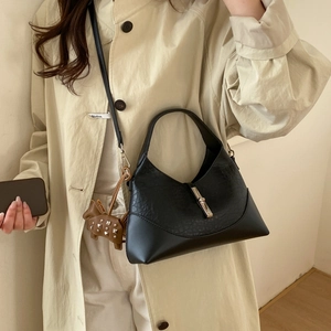 Minimalist black crescent shoulder bag in mixed leather with silver clasp and horse charm