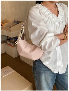 Pink patent leather hobo bag featuring a LOVE & DESIRE print and decorative woven charm