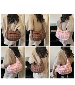 Quilted crossbody half-moon bag in brown and pink, showing back view on model