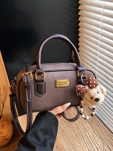 Dark brown leather Boston bag with a bear charm and gold metal plate for stylish women
