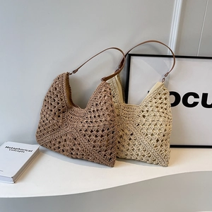 Hollow woven hobo shoulder bag with leather straps for beach vacation use