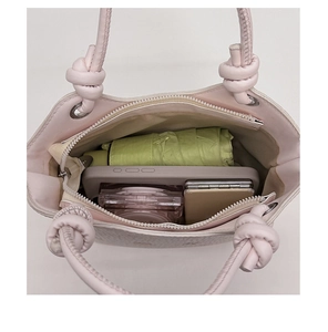 Top view of pink bucket bag interior showing spacious storage for phone and umbrella