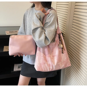 Detailed view of pink tote bag with coffee cup charm and matching makeup pouch