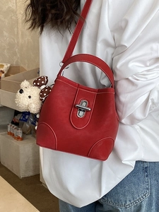 Red faux leather bucket bag with silver twist lock and cute plush bear charm decoration