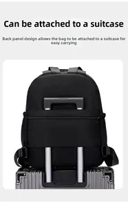 Detail view of black travel backpack with integrated luggage strap for suitcase handles