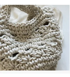 Close-up detail of the chunky hand-woven cotton rope texture on this cream beach bag