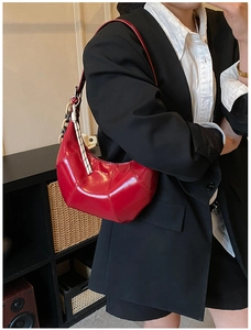 Detail of red crescent moon shoulder bag with glossy patent leather and love design print