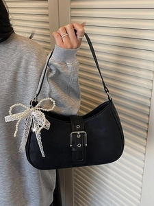 Fashionable black shoulder bag with pearl bow pendant and silver buckle detail