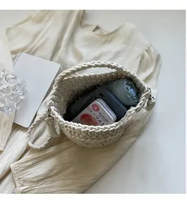 Interior view showing capacity of a cream woven beach bag with phone and umbrella