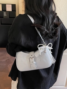 Light blue patent leather shoulder bag featuring a large pearl lace bow and heart pendant