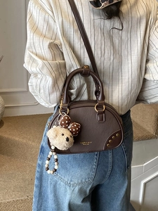 Retro dark brown crossbody pillow bag with teddy bear charm and gold logo detail