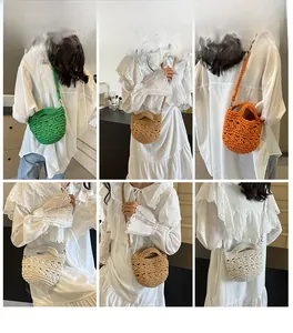 Close-up of handmade woven straw crossbody bags in green, khaki, orange and beige colors