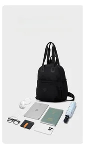 Detail view of large capacity black backpack showing storage space with tech and books