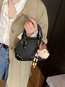 Fashionable matte black half-moon pillow bag with plush bear charm and beaded chain