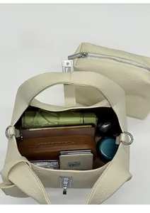 Spacious bucket bag interior showing large capacity for umbrella and cosmetics