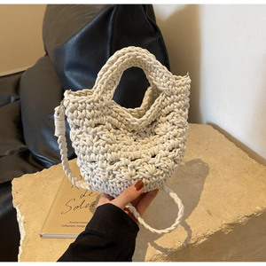 Detailed macro view of cream hand-woven crochet bag with textured rope patterns