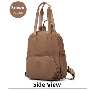 Detail view of brown nylon backpack with top handle and adjustable shoulder straps
