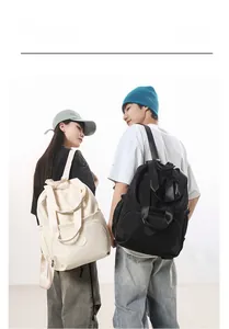 Detail view of large capacity nylon backpacks in cream and black for daily commute