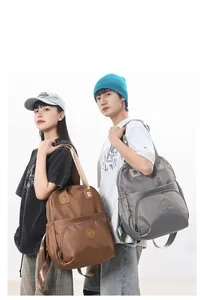 Dual view of nylon waterproof backpacks in dark brown and smoke gray with zippers