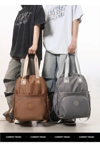 Detail of grey and brown waterproof nylon backpacks with spacious pockets and straps