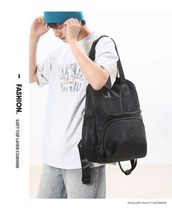 Detail view of premium black genuine leather backpack showing large storage and texture