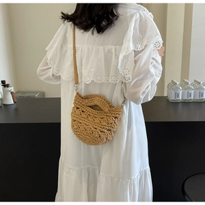 Detail of handwoven crochet crossbody bag featuring intricate hollow textures and strap