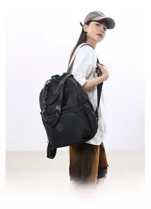 Detail view of large capacity black fashion backpack featuring waterproof nylon fabric and pockets