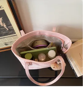 Top view of large pink tote bag interior showing ample space with plush bear charm