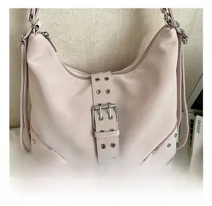 Detail of silver metal rivets and buckle on a pink punk style faux leather tote bag