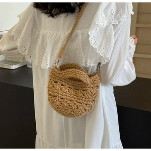 Close-up of brown hand-woven crochet crossbody bag with silver metal swivel hooks