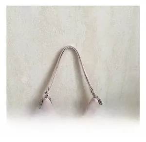 Detail of pink tote bag showing wide shoulder strap and silver metal adjustment buckle