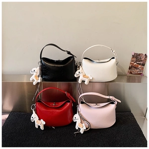 Detailed view of four colorful minimalist Lindy style handbags with horse charms and metal locks