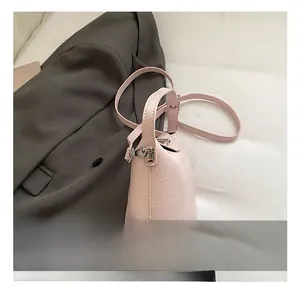 Detailed macro view of the silver hardware and textured pink leather on the bucket bag