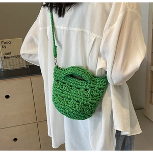Detailed macro view of vibrant green hand-woven crochet crossbody bag with hollow grid texture