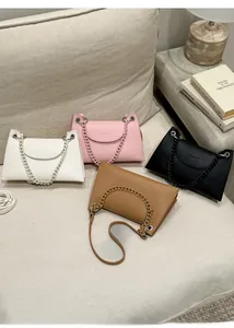 Detail of lychee textured leather handbags with thick chain handle and long strap