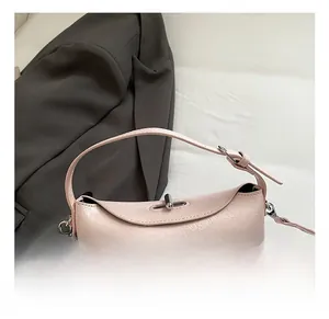 Detail showing pink lychee grain leather handbag with silver clasp and top handle