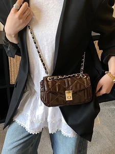 Deep brown quilted leather crossbody bag with chain strap and gold twist-lock closure