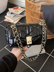 Classic black quilted leather crossbody bag with gold chain strap and elegant metal lock