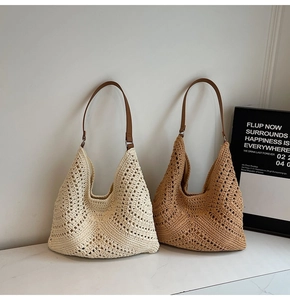Detail of woven hobo bags in beige and brown with hollow V-pattern and leather straps