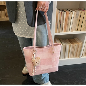 Pink geometric pattern tote bag with cute brown bear charm and brand logo detail