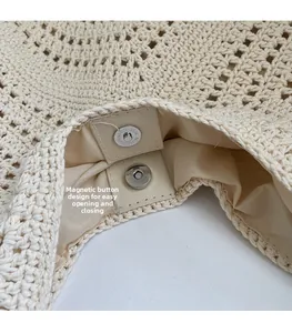 Detailed macro view of the convenient magnetic snap closure on a beige woven tote bag