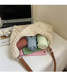 Detail view of a woven tote bag with hollow knit patterns and large interior capacity