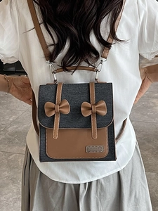 Preppy style grey denim backpack with brown leather accents and bow details for women