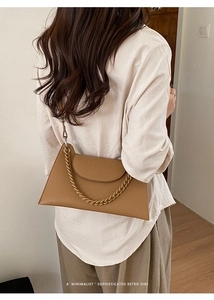 Brown retro shoulder bag with chain detail and pebble leather shown on model back view