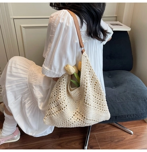 Detail of crochet knit tote bag with hollow patterns and premium brown leather shoulder strap