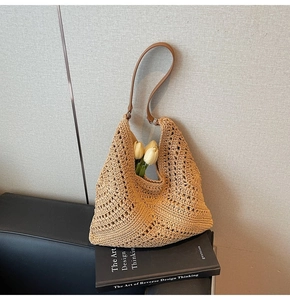 Close-up of the hollow star-shaped knit pattern on this beige crochet tote bag
