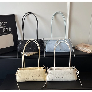 Group display of minimalist baguette bags in black, blue, yellow, and cream white colors