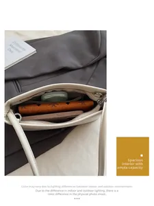 Top view of the spacious inner compartment of this beige crossbody bag showing storage