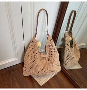 Detailed macro view of beige crochet tote bag with hollow diamond pattern and leather strap