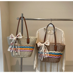 Detail of straw tote bags with floral lace bows and colorful woven texture accents